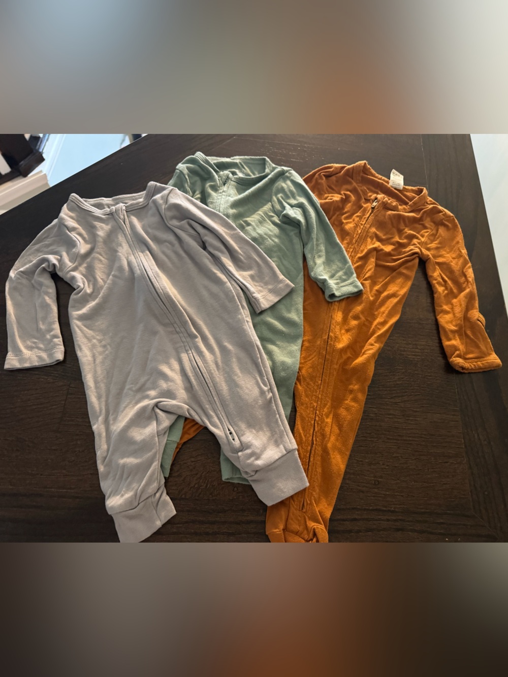 Three-pack footie set in gray, sage, and rust Kate Quinn + other brands